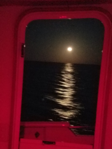 The full moon taken from the pilot house. The red light is for night driving.